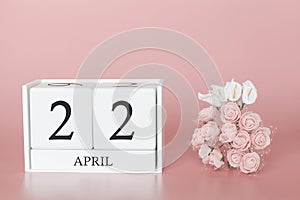 April 22nd. Day 22 of month. Calendar cube on modern pink background, concept of bussines and an importent event