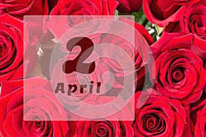 April 2nd. Day of 2 month, calendar date. Natural background of red roses. A bouquet of dark red roses