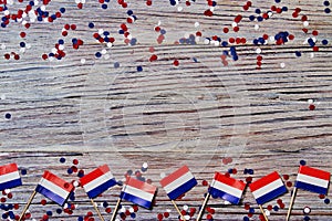 April 30 . mini flags with paper confetti lie on the edges of the wooden background. The concept of independence Day of the