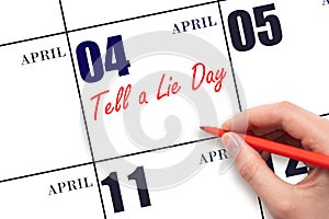 April 4. Hand writing text Tell a Lie Day on calendar date. Save the date.