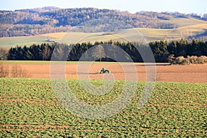 April 7 2018 - Saxony, Germany: a Tractor working on the farm, a modern agricultural transport, a farmer working in the field,