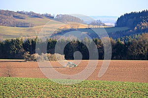 April 7 2018 - Saxony, Germany: a Tractor working on the farm, a modern agricultural transport, a farmer working in the field,