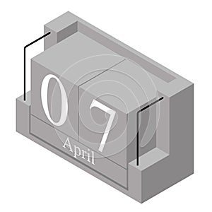 April 7th date on a single day calendar. Gray wood block calendar present date 7 and month April isolated on white background.