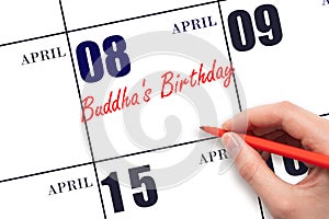 April 8. Hand writing text Buddha's Birthday on calendar date. Save the date.