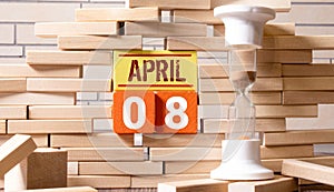 April 8th. Day 8 of month, Calendar date. White cubes with text on black background with reflection