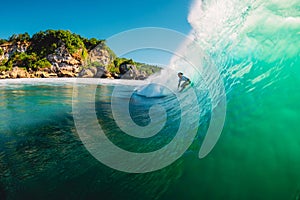 April 18, 2019. Bali, Indonesia. Surfer ride on barrel wave. Professional surfing at big waves in Padang Padang