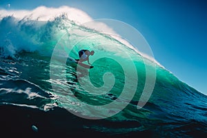 April 18, 2019. Bali, Indonesia. Surfer ride on barrel wave. Professional surfing at big waves in Padang Padang