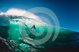 April 18, 2019. Bali, Indonesia. Surfer ride on barrel wave. Professional surfing at big waves in Padang Padang