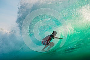 April 23, 2018. Bali, Indonesia. Surfer ride on big barrel wave at Padang Padang. Professional surfing in ocean