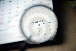 April 2020 Calender under magnifying glass.