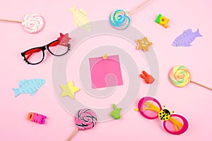 April Fools ' Day celebration background with paper fish, sticky note and decor on pink background. All Fools ' Day, humor, prank,