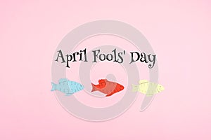 April Fools ` Day celebration background with paper fish and text on pink background. All Fools ` Day, humor, prank, joke concept