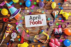 April Fools' Day Celebration with Prankster's Toolkit and Festive Decorations on Wooden Background photo
