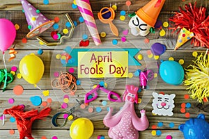 April Fools' Day Celebration with Prankster's Toolkit and Festive Decorations on Wooden Background photo