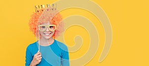 april fools day. happy childhood. girls birthday party. happy funny kid in curly wig and crown. Funny teenager child in