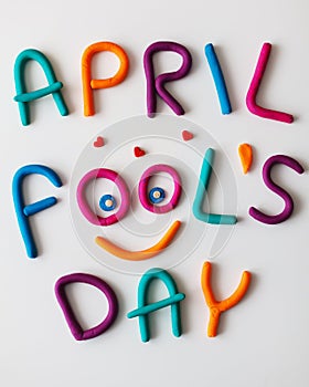 April Fools Day phrase made of plasticine colorful letters on background