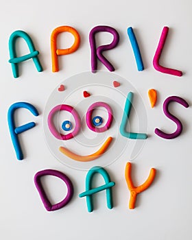 April Fools Day phrase made of plasticine colorful letters on background photo