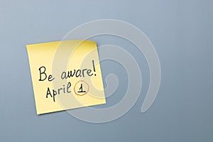 April fools day reminder on yellow sticky note. be aware and do not let be fooled