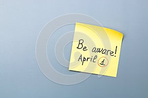 April fools day reminder on yellow sticky note. be aware and do not let be fooled