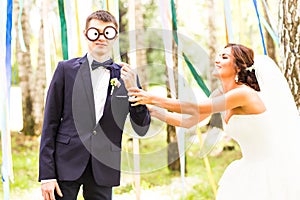 April Fools' Day. Wedding couple have fun with mask.