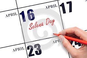April 16. Hand writing text Selena Day on calendar date. Save the date. photo