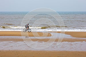 North Sea Hague Scheveningen Netherlands dutch sun Den Haag ride bicycle bicyclist shore reflection morning men