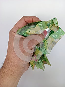 April 10 2024 Toronto Ontario Canada Canadian twenty dollar bills in a brown persons hand