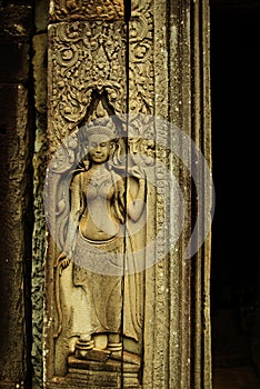 Apsara dancer bas-relief on ancient Angkor temple photo