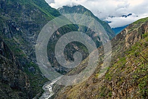 Apurimac river : Green steep slopes of valley with water in the middle, the Choquequirao trek, Peru