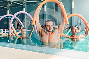 Aqua aerobics exercises, women with male trainer