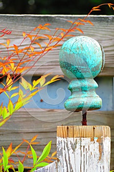 Aqua ball newel post top on white fence