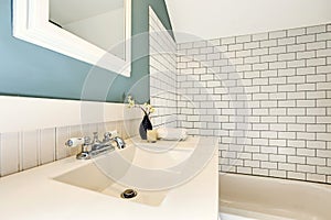 Aqua bathroom with white tile wall trim.