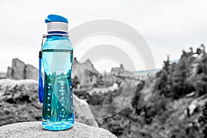 Aqua Blue Fitness Water Bottle with Mountains in Background