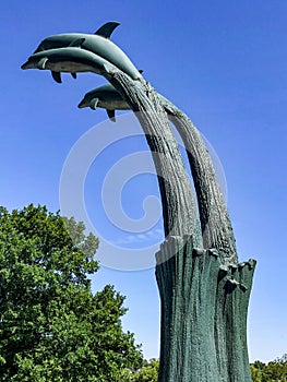 Statute of dolphins jumping out of water