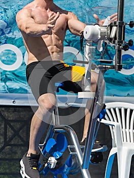 Aqua Gym: Aerobics and Fitness Instructor in front of a group of people in the Water Performing Exercises with Bike