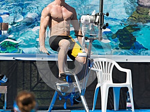 Aqua Gym: Aerobics and Fitness Instructor in front of a group of people in the Water Performing Exercises with Bike