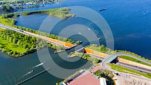 Aquaduct Veluwemeer, Nederland. Aerial view from the drone. A sailboat sails through the aqueduct on the lake above the highway