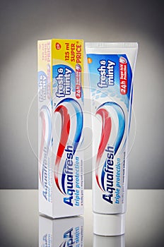 Aquafresh toothpaste isolated on gradient background.