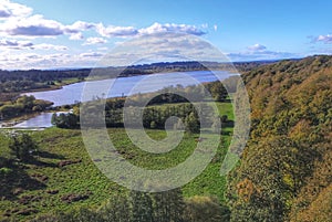 Aqualate mere under blue skies and white clouds drone imagery