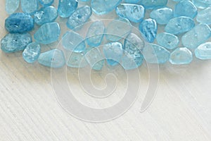 Aquamarine is blue. Natural stone is blue aquamarine. The background is aquamarine. Place for text. Card