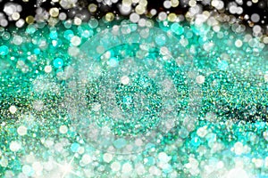 Aquamarine Sparkling Lights Festive background with texture. Abstract Christmas twinkled bright bokeh defocused and