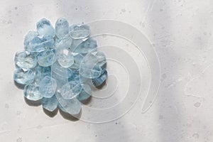 Aquamarine stone. Natural stone and aquamarine crystals on a white background. Beautiful aquamarine stones. Copy space for your photo