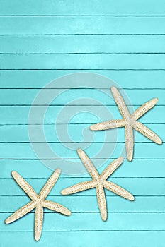 Aquamarine, turquoise, blue boards with starfish and seashell. Travel, summer, spring background. Pier, beach