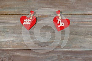 Aquarius and Capricorn. signs of the zodiac and heart. wooden ba