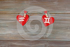 Aquarius and twins. signs of the zodiac and heart. wooden backgr