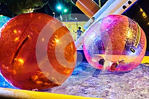 Aquazorbing. Kids playing. zorbing in the swimming pool