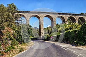 Aqueduct ancient bridge over highway in Fontaine de Vaucluse, Provence, France.