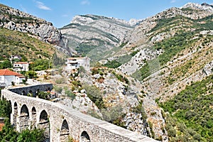 Aqueduct on a background of mountains. Stari Bar, Montenegro
