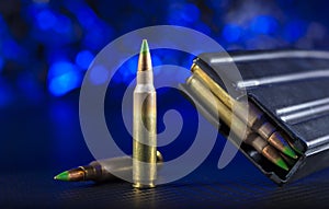 AR-15 ammo and magazine with blue background