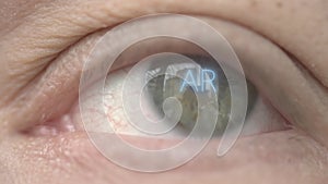 AR or Augmented Reality text on human eye. Modern technology related macro shot